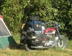 Photo of a Triumph motocycle packed with camping gear